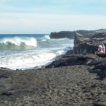 a rocky beach next to the ocean