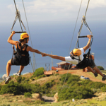 a group of people on a swing in a body of water