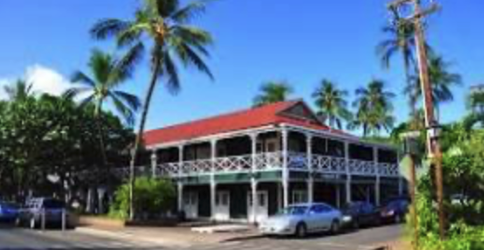 a palm tree in front of a building